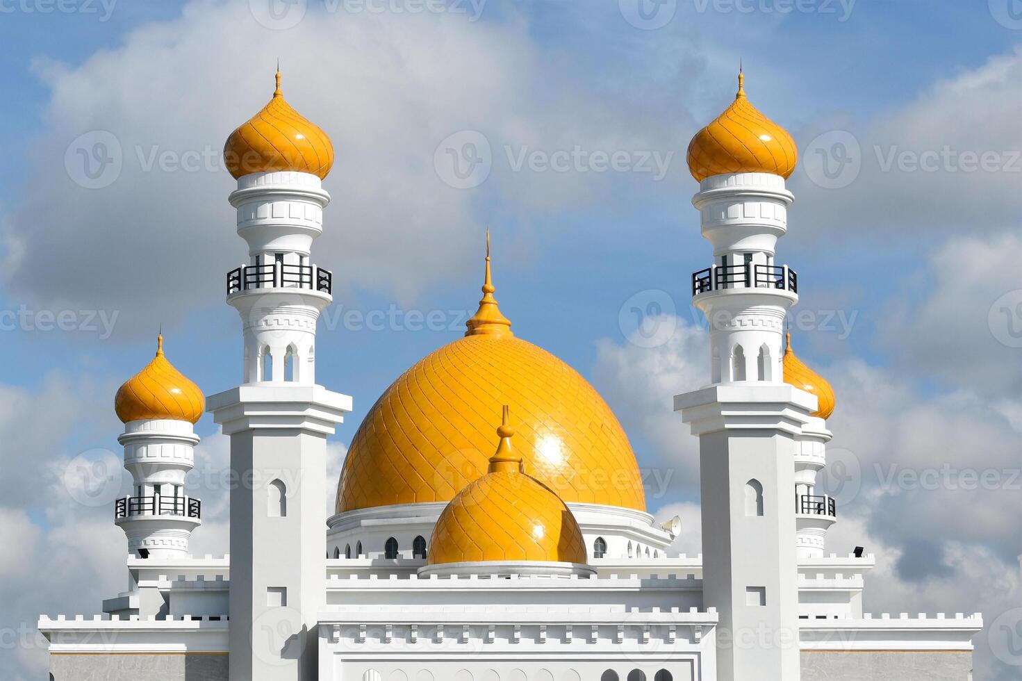 Beautiful white mosque with yellow tops photo