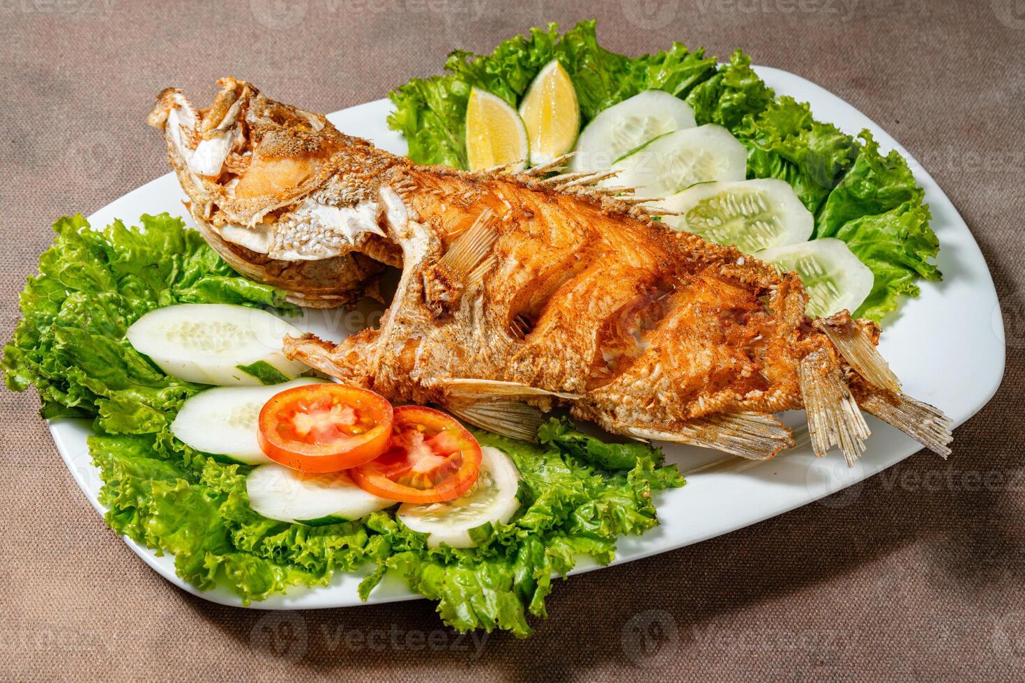 Deep fried crispy grouper fish with sambal dabu dabu photo