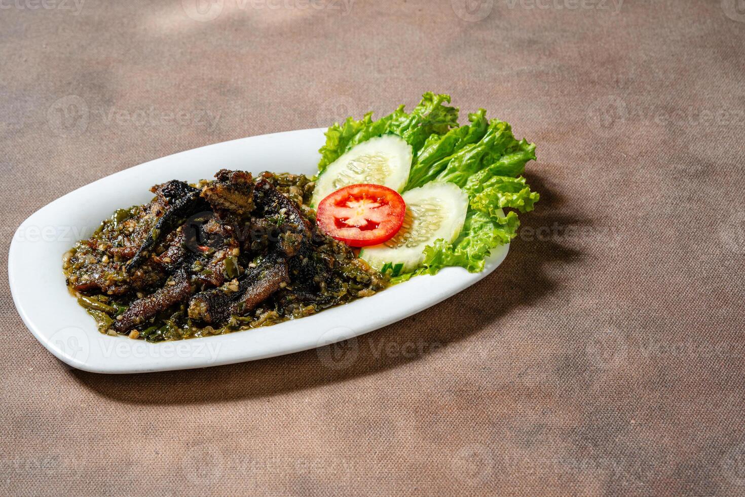 Fried eel with green chili sauce or belut goreng cabe ijo photo