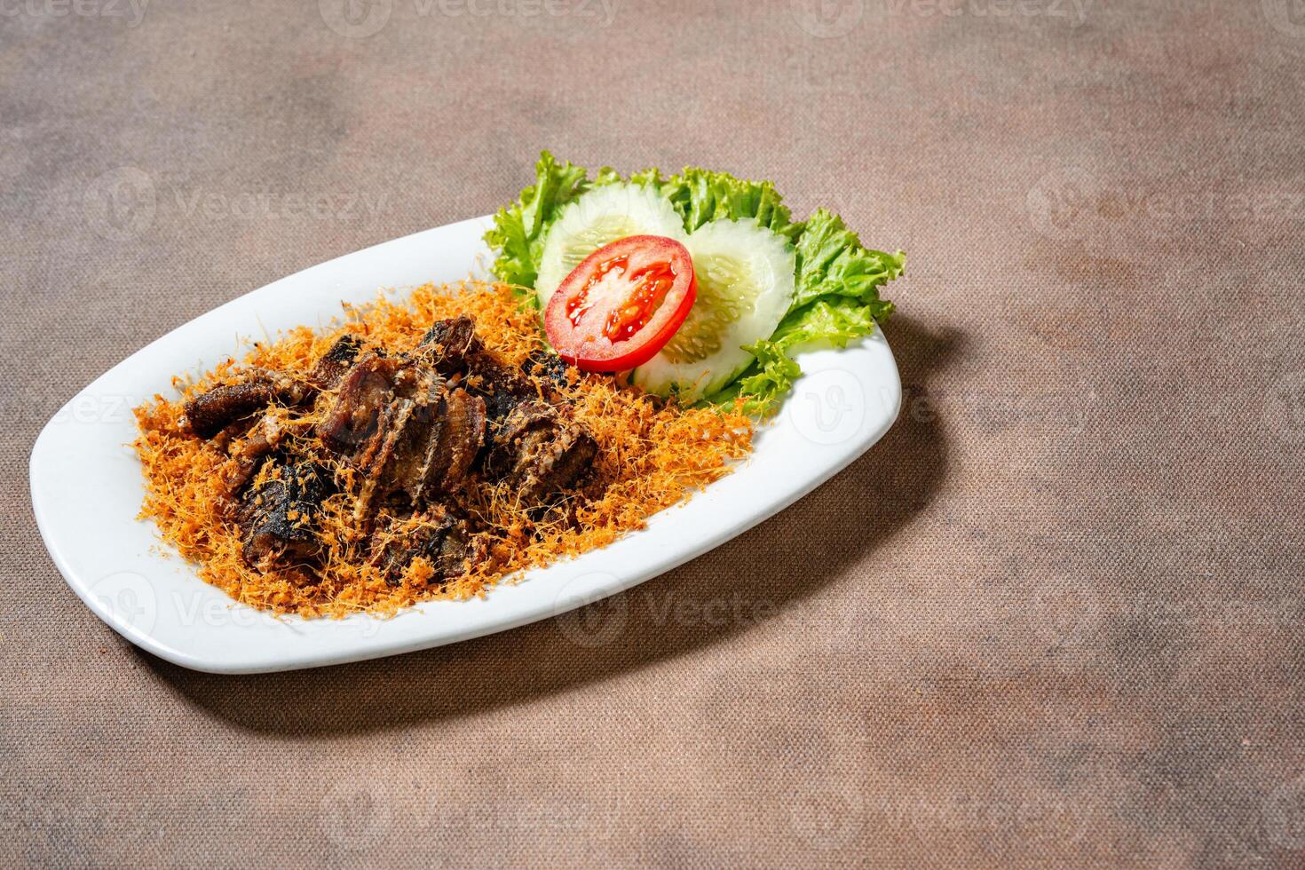 Fried eel with grated galangal or belut goreng lengkuas photo