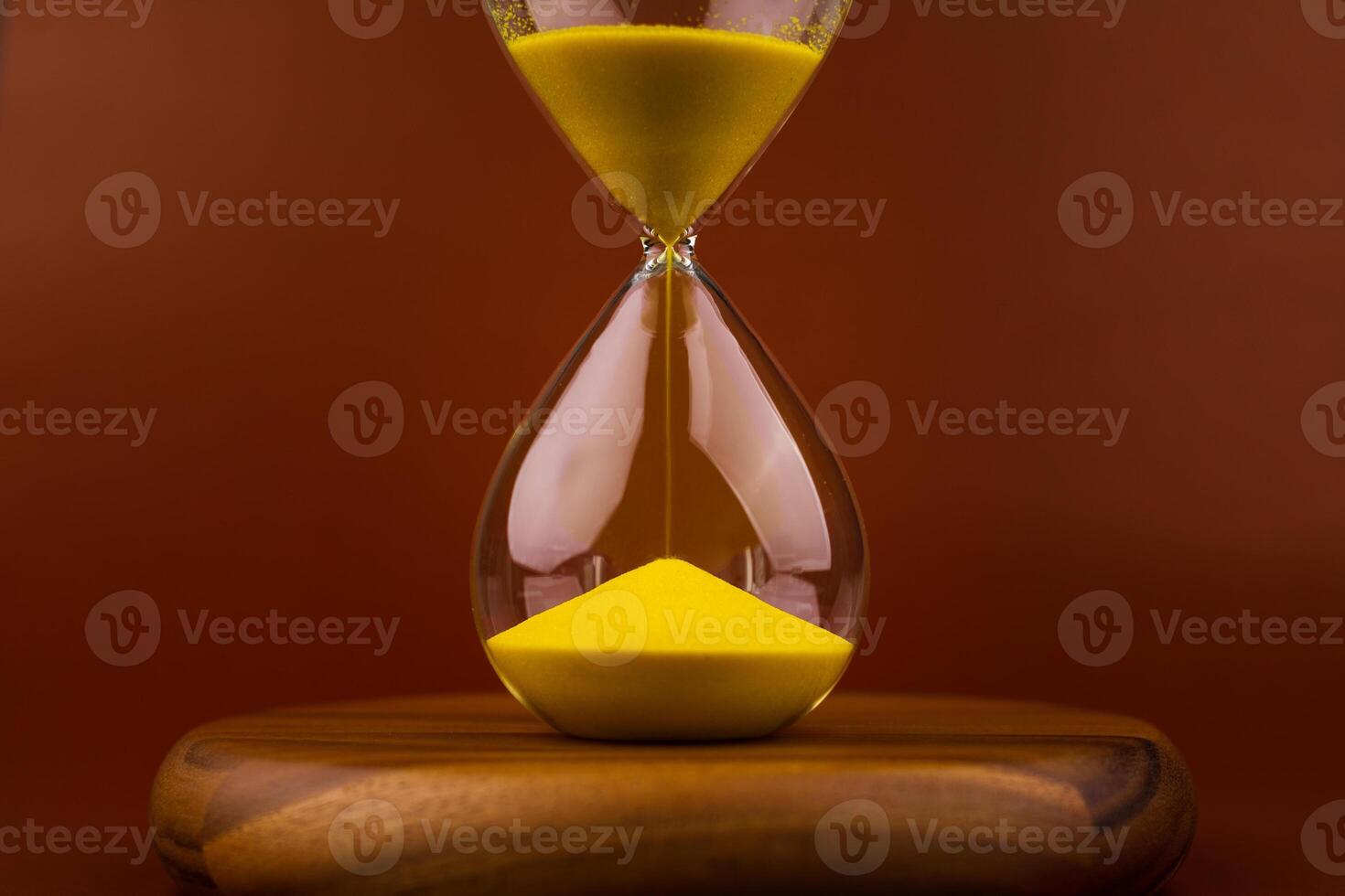 The hourglass indicates limited time and deadlines in which work is competing against the precious time in life. photo