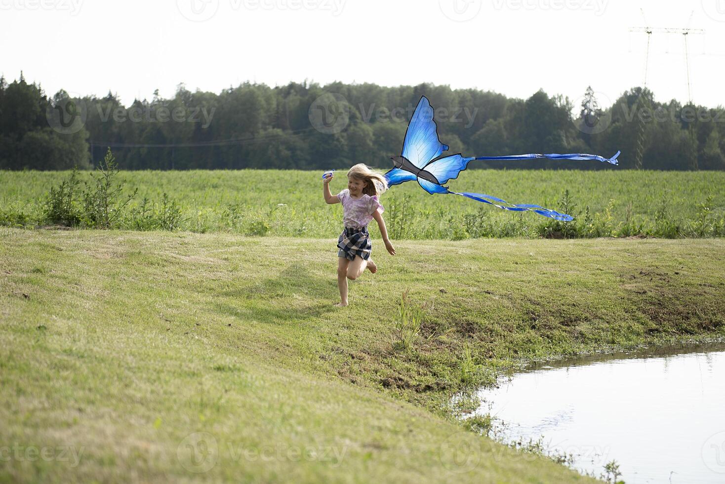 Little happy child girl running with kite photo
