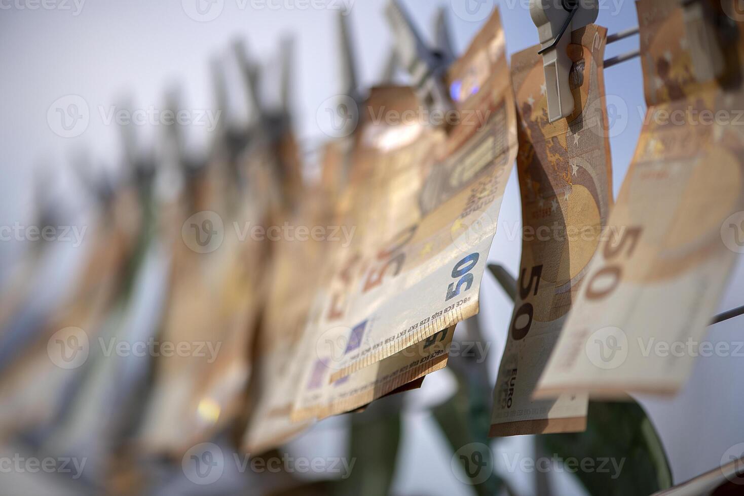 Washed Euro paper bills. Drying euro on a string. photo