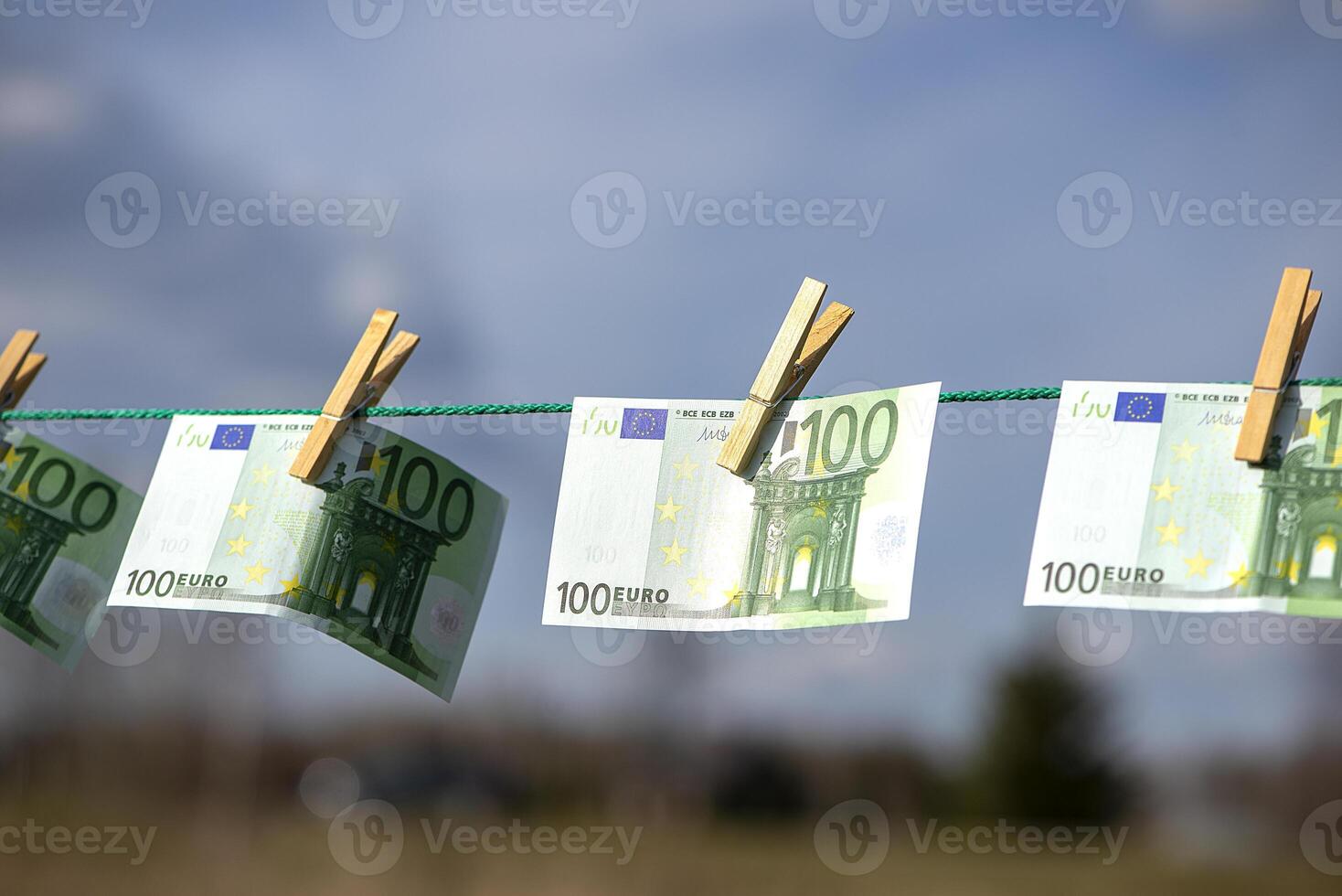 Euro banknotes hanging with clothespin on clothesline. Money laundering business concept. Abstract conceptual image photo
