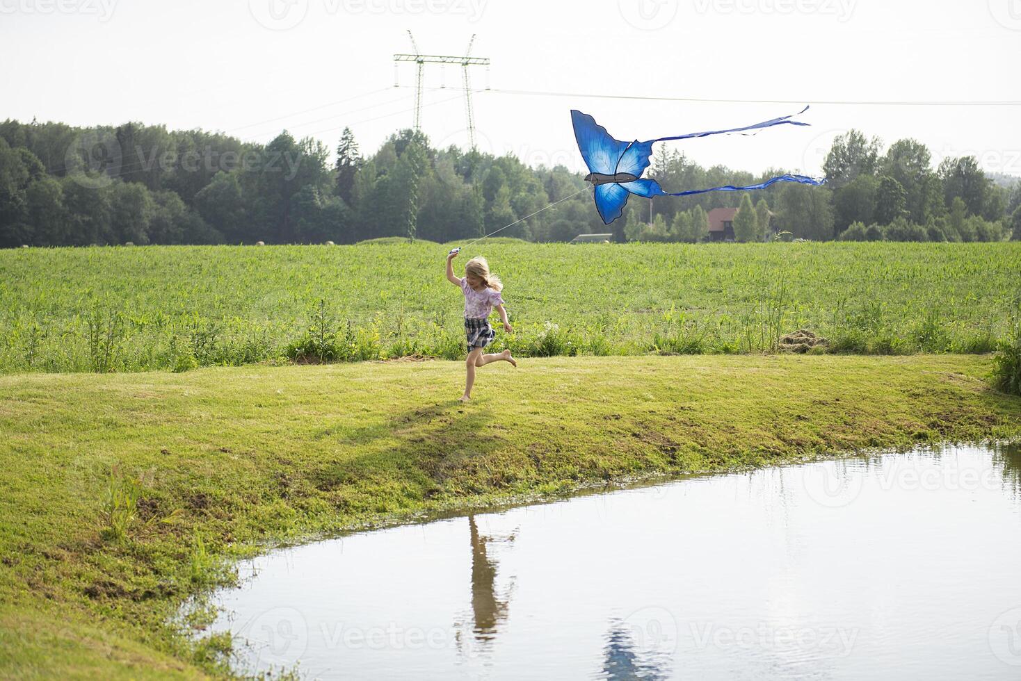 Little girl flying a kite photo