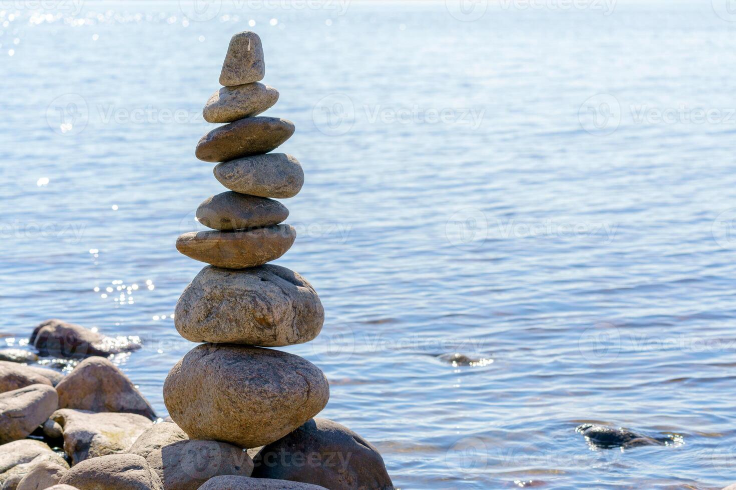 Pyramid of stones. Unstable balance of stone objects. Idyllic state of nature. photo
