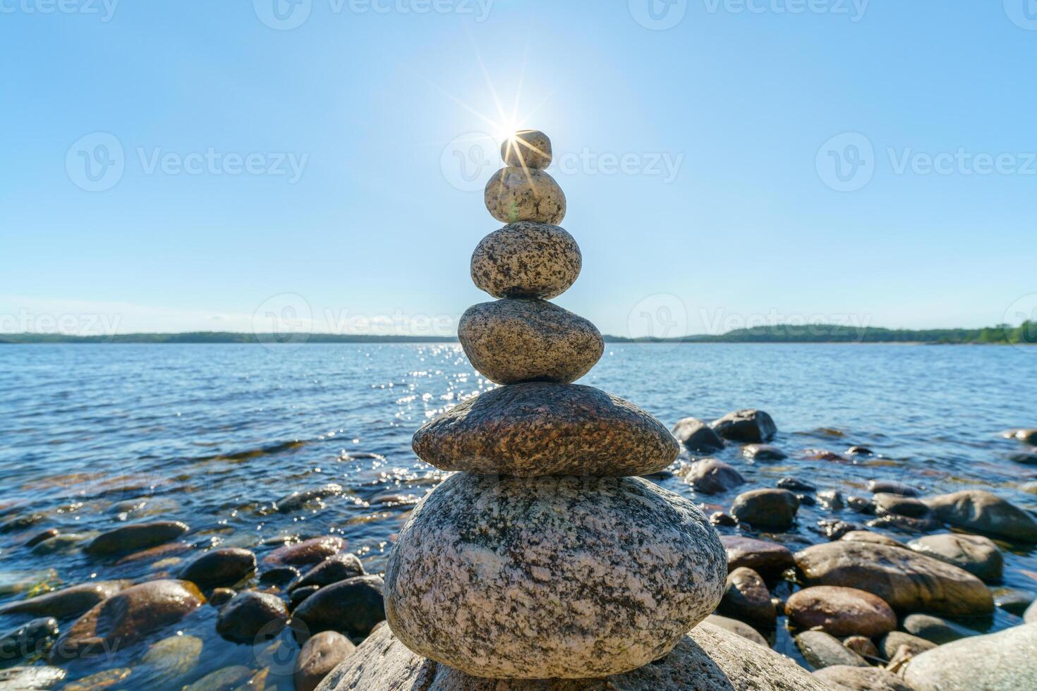 Pyramid of stones. Unstable balance of stone objects. Idyllic state of nature. photo