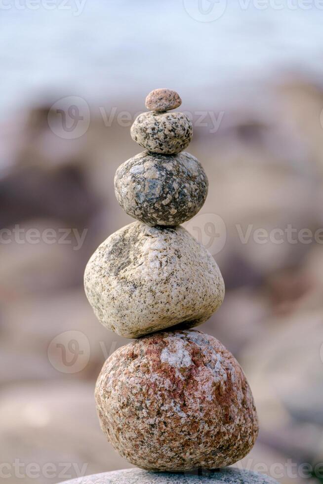 Pyramid of stones. Unstable balance of stone objects. Idyllic state of nature. photo