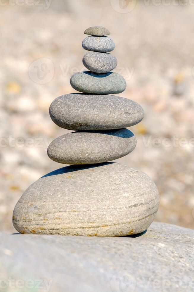 Pyramid of stones. Unstable balance of stone objects. Idyllic state of nature. photo