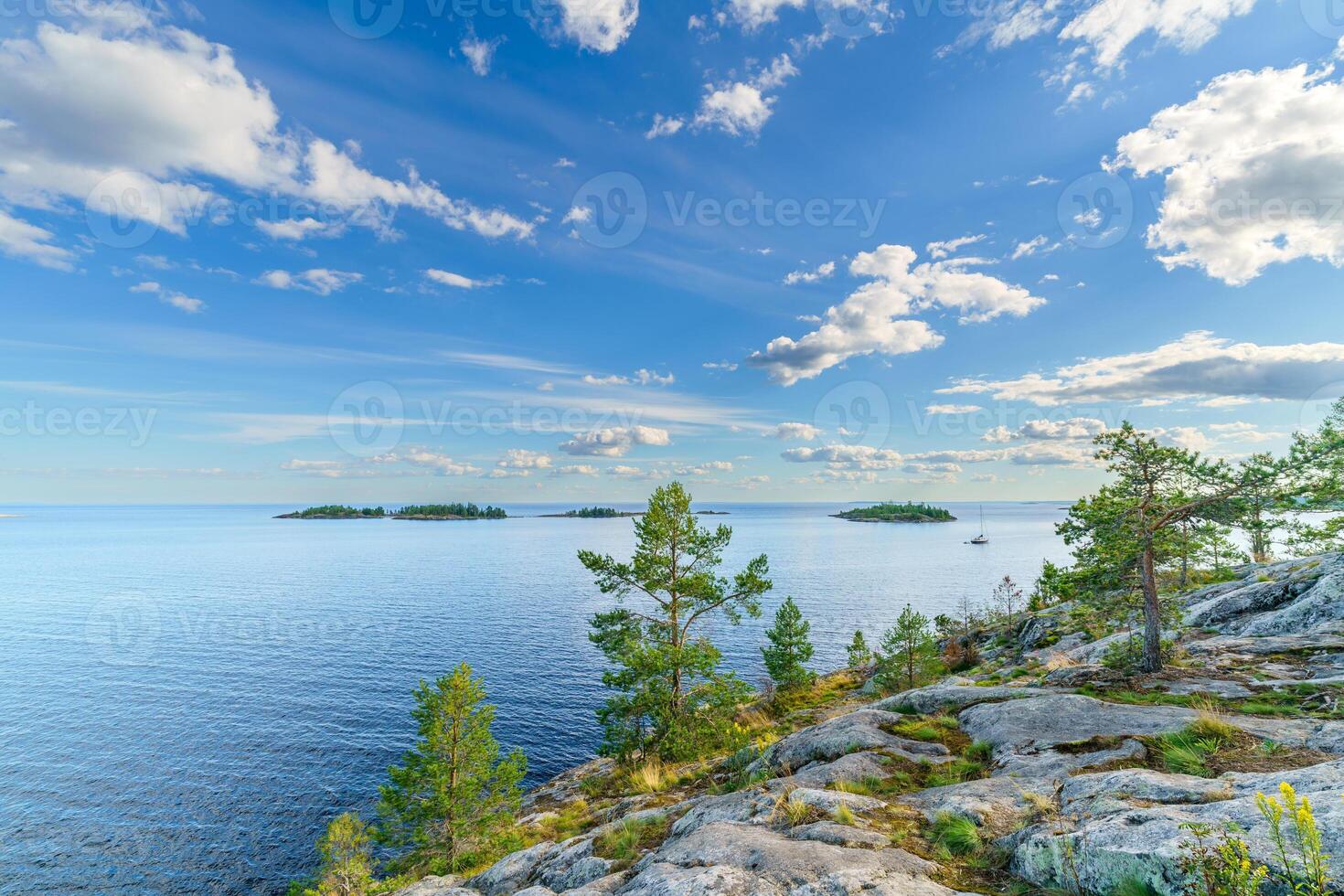 Beautiful stones and pine trees on the lake. Landscape of wild nature. photo