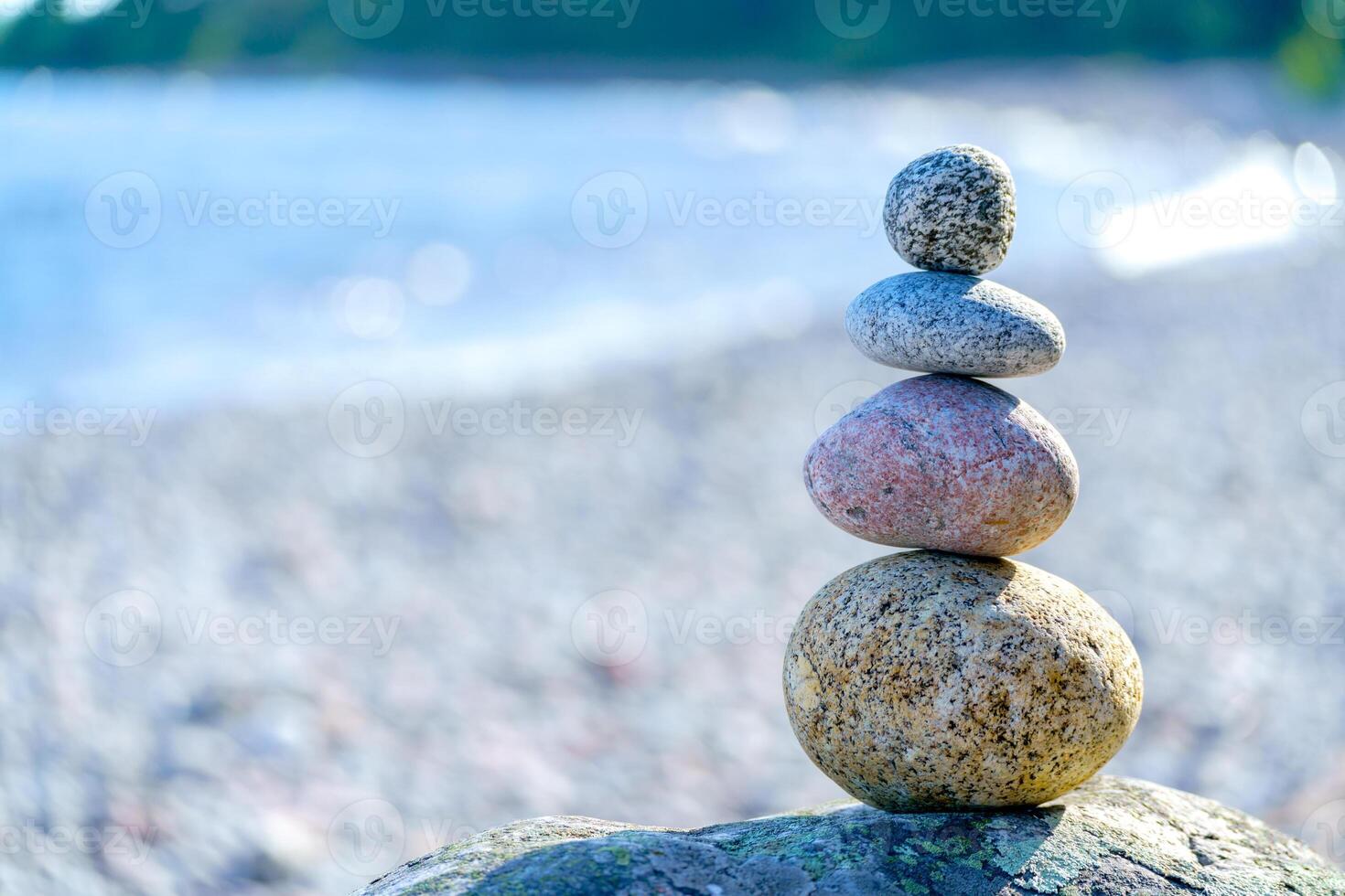 Pyramid of stones. Unstable balance of stone objects. Idyllic state of nature. photo