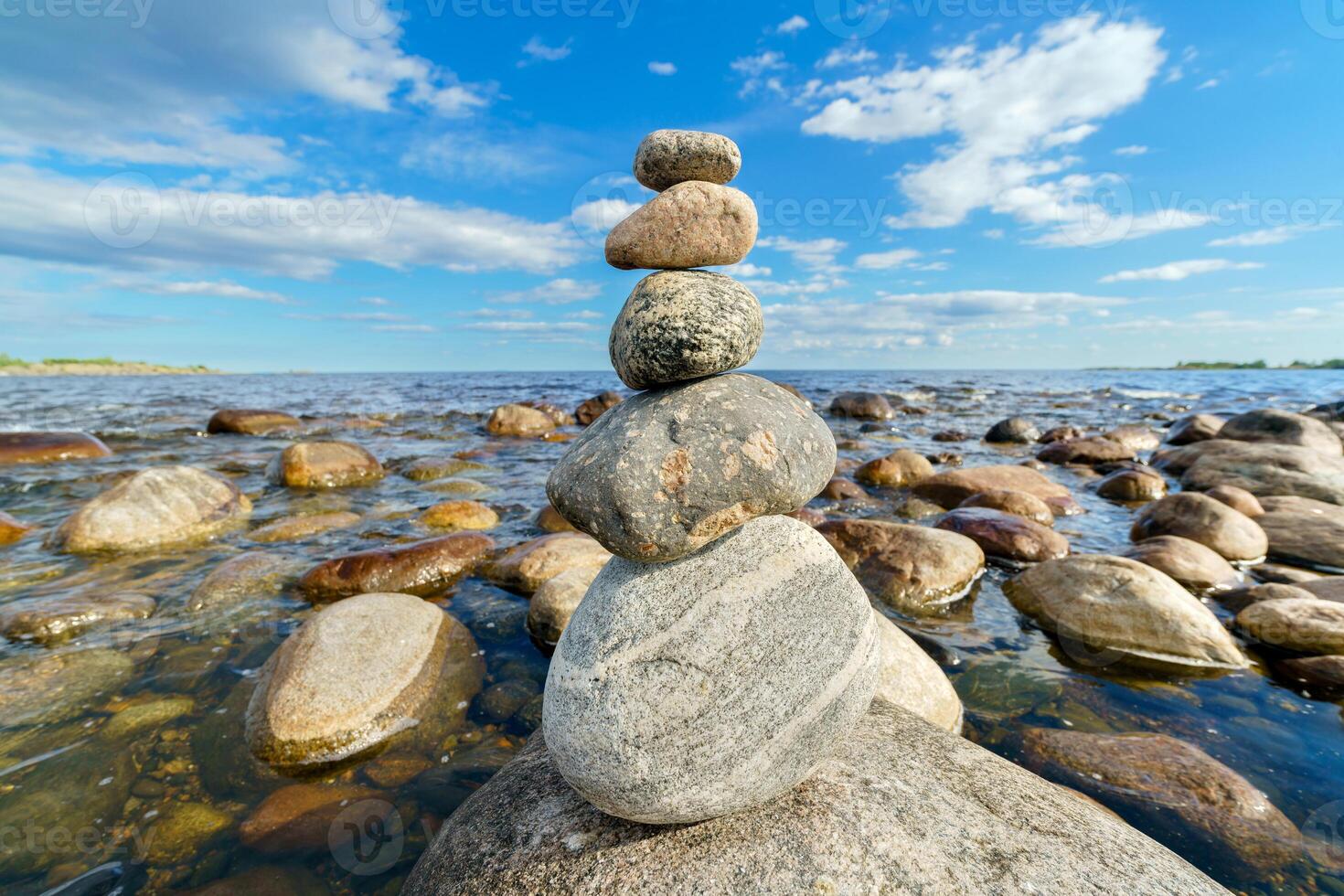 Pyramid of stones. Unstable balance of stone objects. Idyllic state of nature. photo