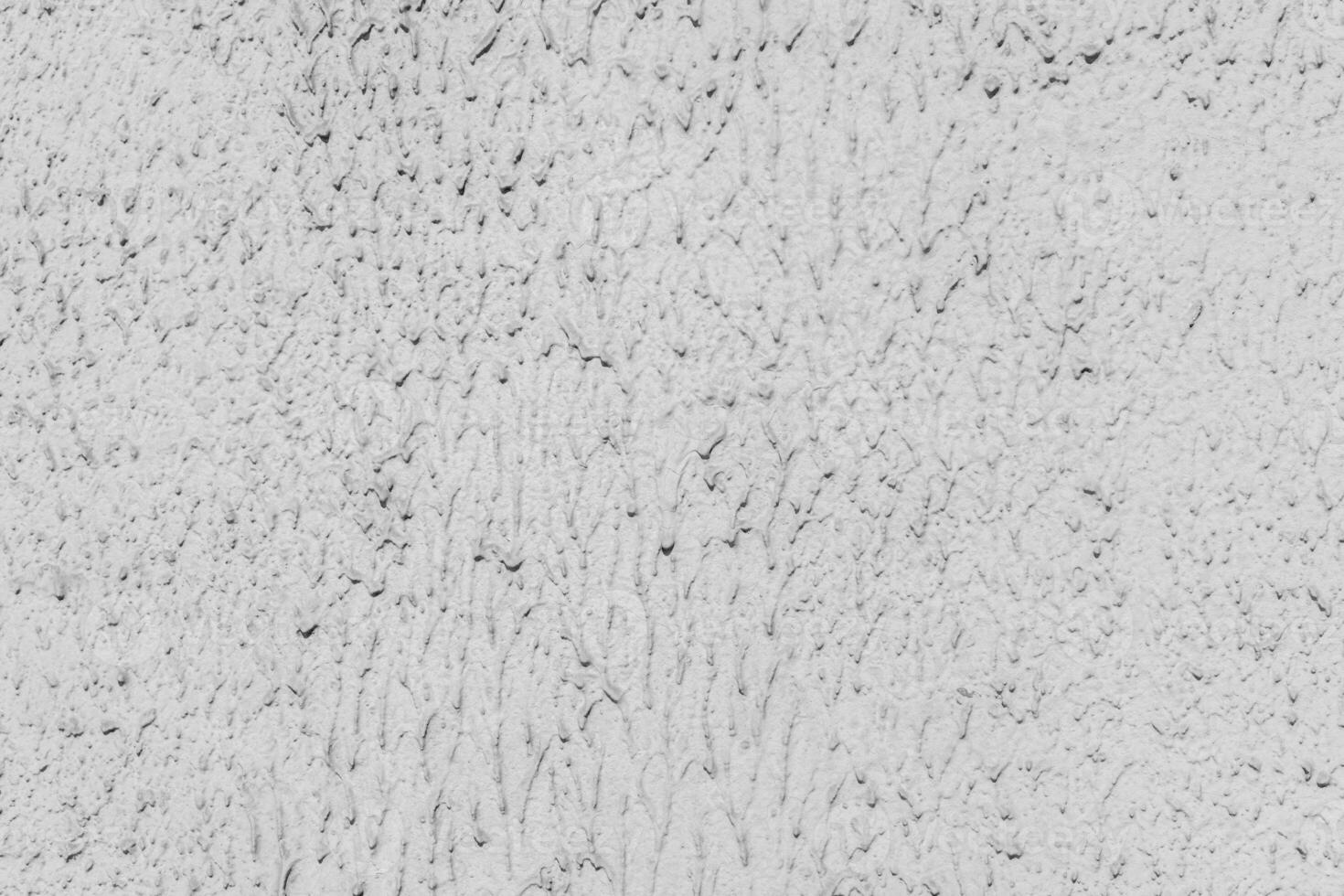 Gray texture of uneven plaster on the wall of the house. photo
