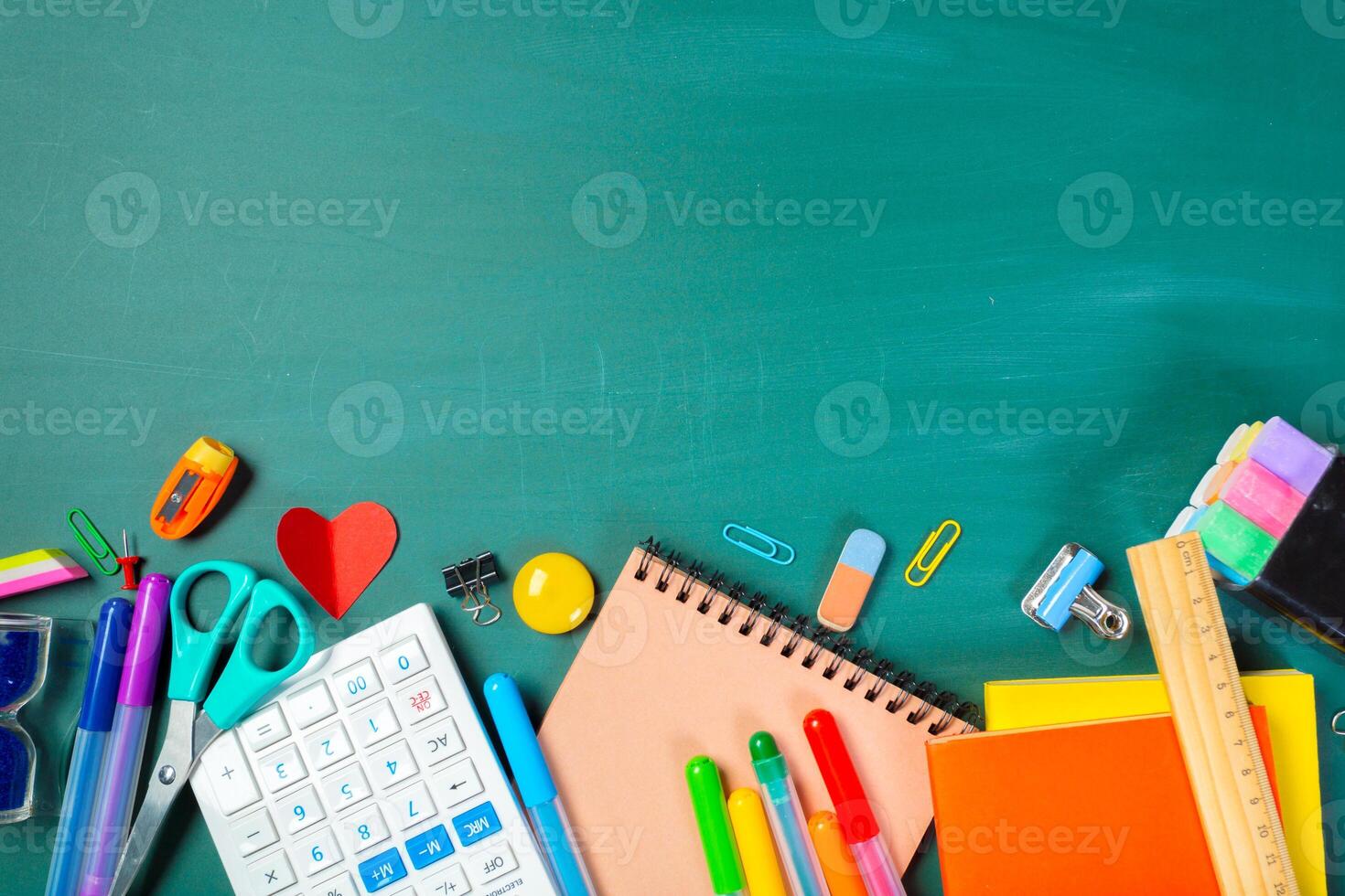 School and office supplies on blackboard photo