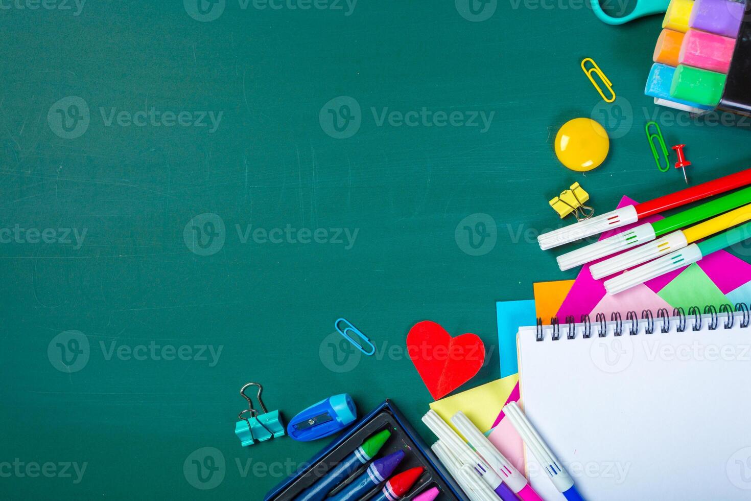 School and office supplies on blackboard photo