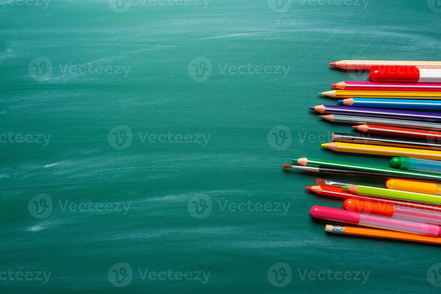 School supplies on chalkboard background photo