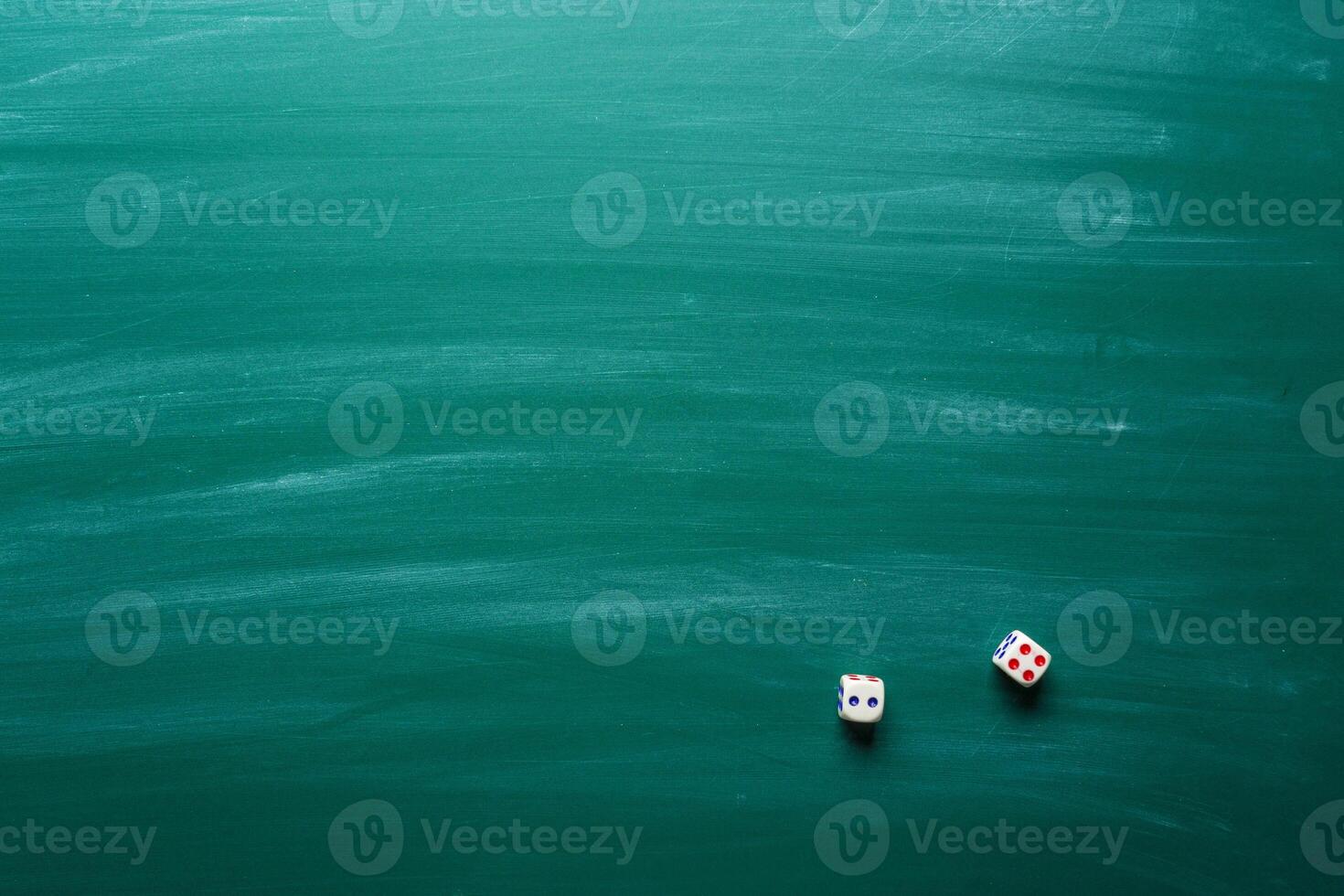 Dice on a chalkboard background photo