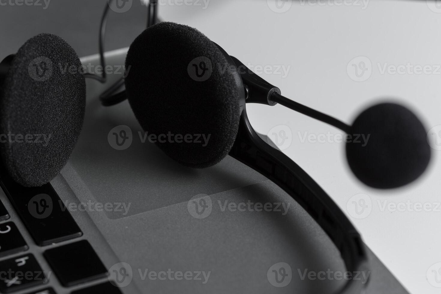call center support concept. headset on keyboard computer laptop photo