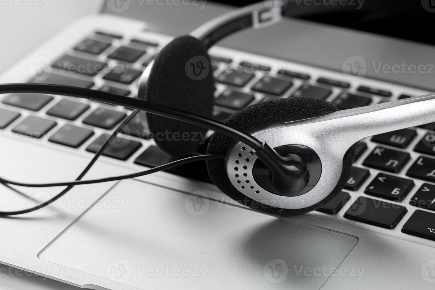 call center support concept. headset on keyboard computer laptop photo