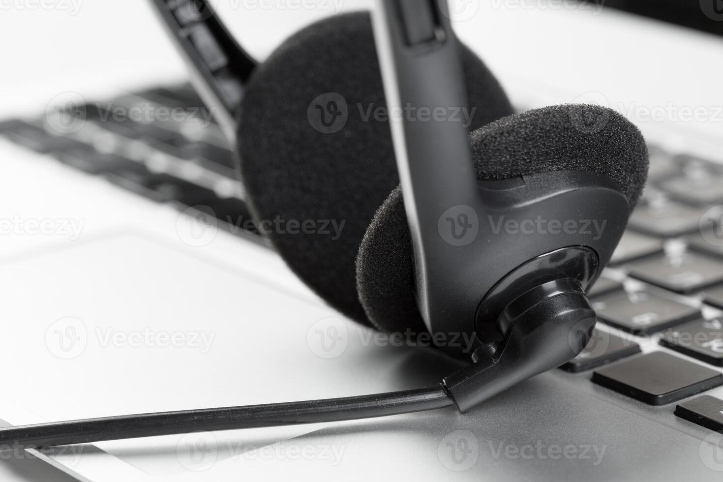 call center support concept. headset on keyboard computer laptop photo