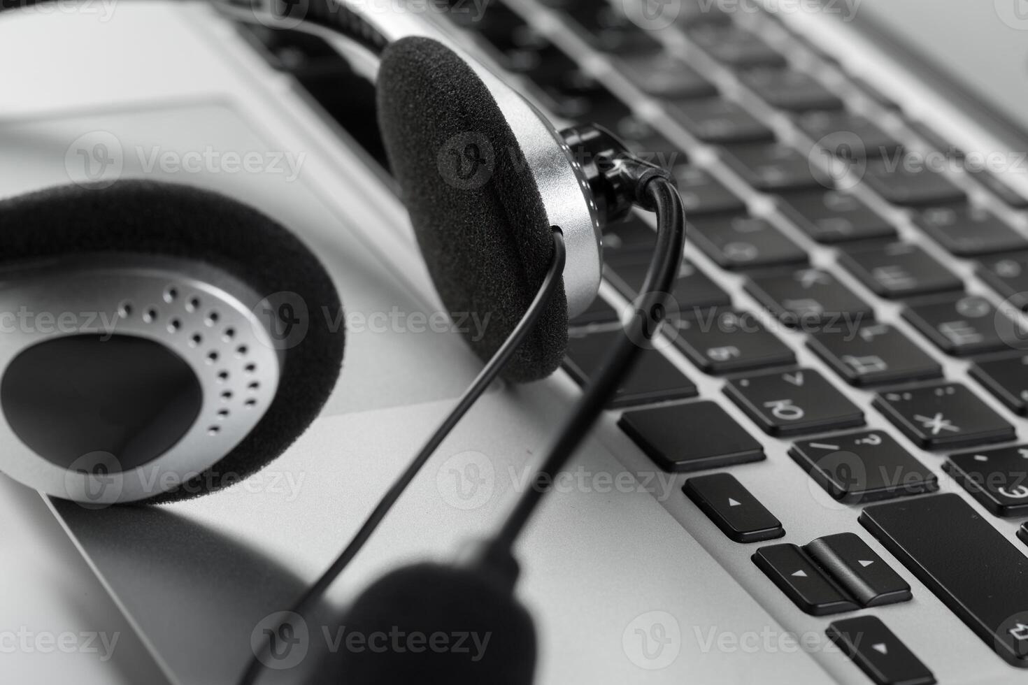 call center support concept. headset on keyboard computer laptop photo