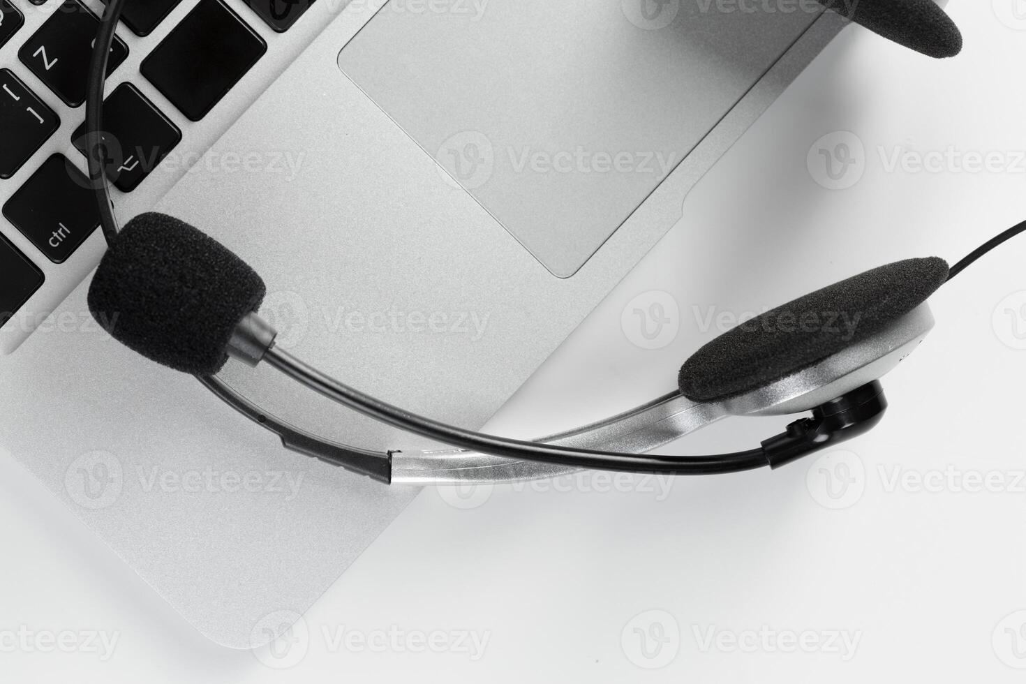 call center support concept. headset on keyboard computer laptop photo