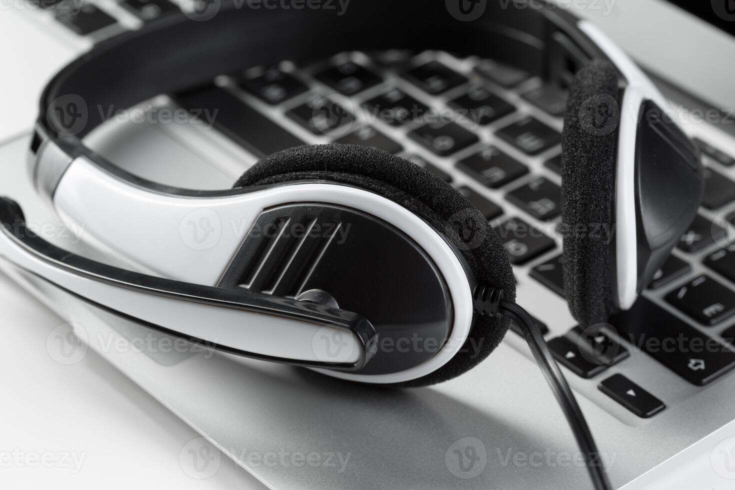 call center support concept. headset on keyboard computer laptop photo