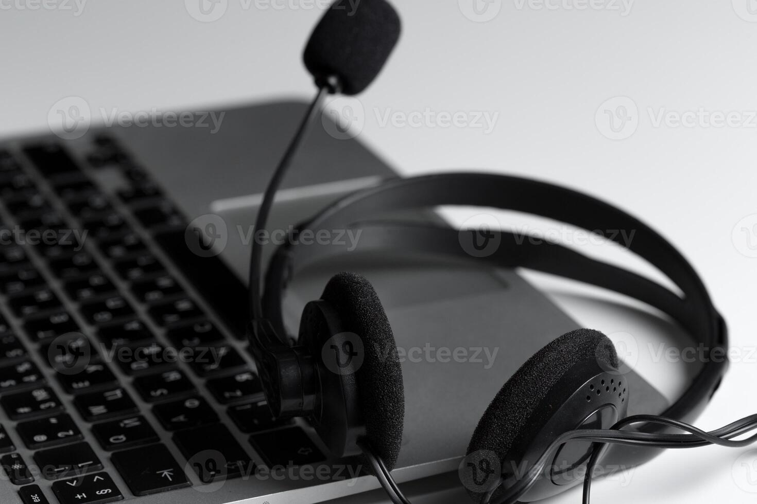 call center support concept. headset on keyboard computer laptop photo