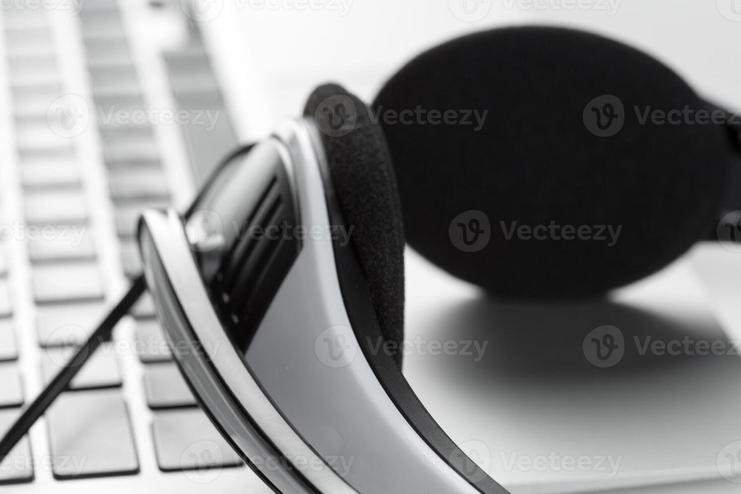 call center support concept. headset on keyboard computer laptop photo