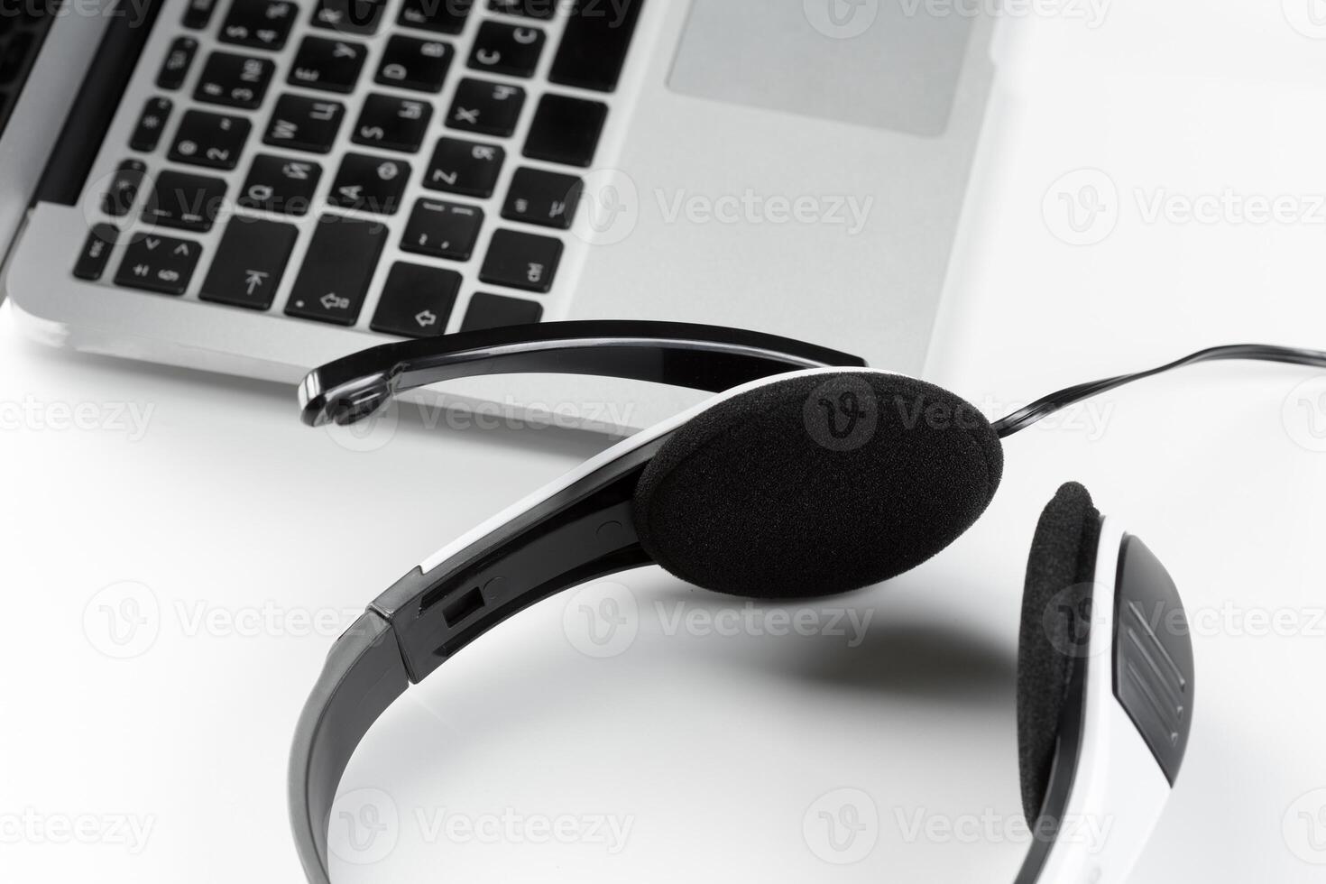 call center support concept. headset on keyboard computer laptop photo