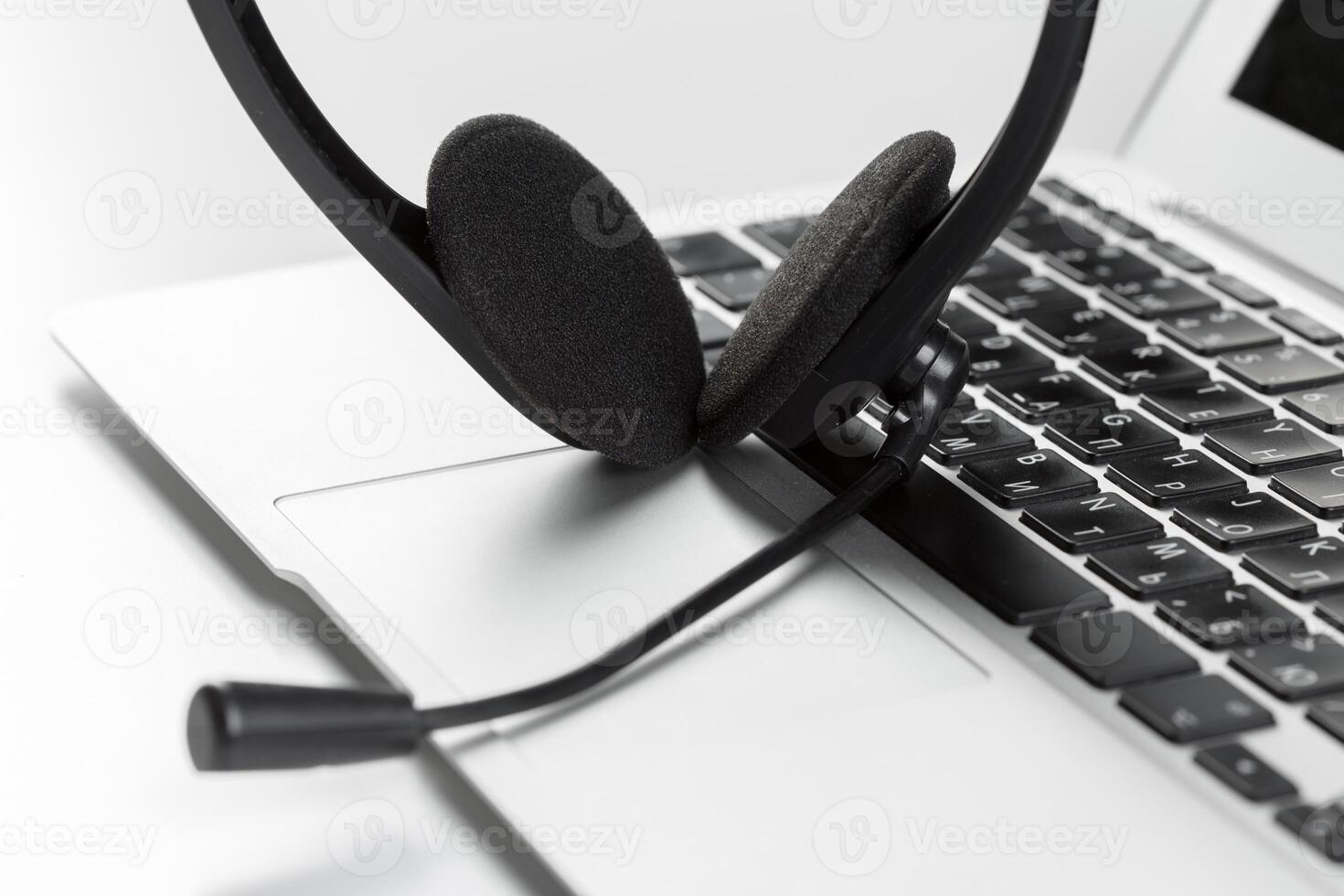 call center support concept. headset on keyboard computer laptop photo