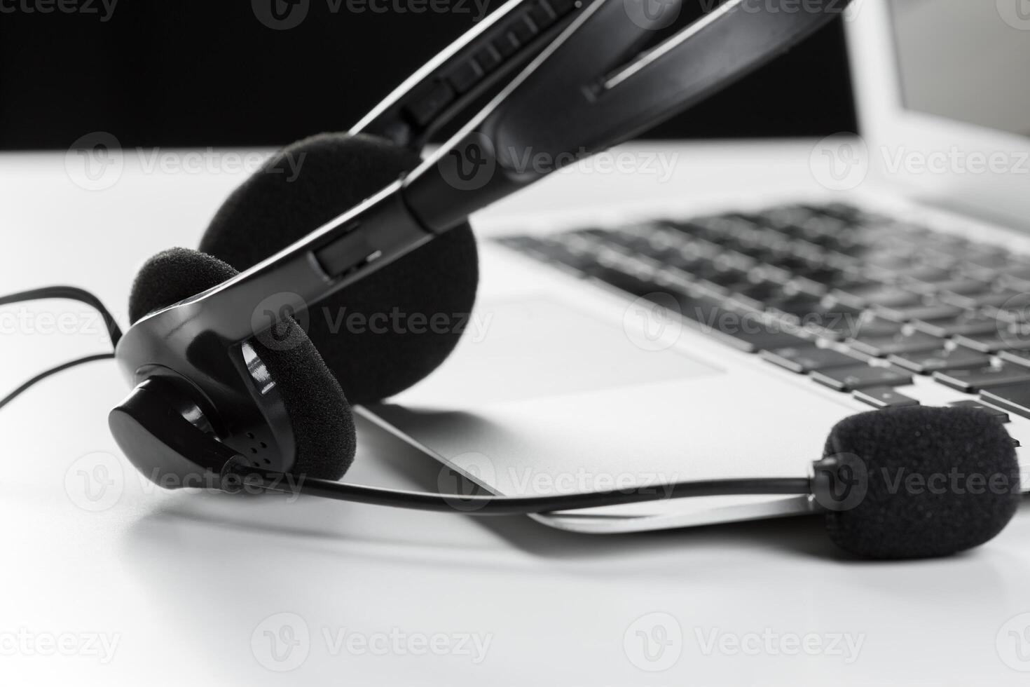 call center support concept. headset on keyboard computer laptop photo