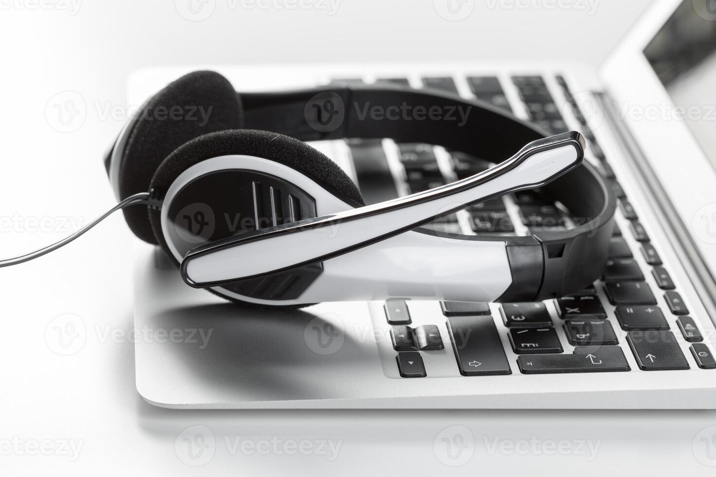 call center support concept. headset on keyboard computer laptop photo