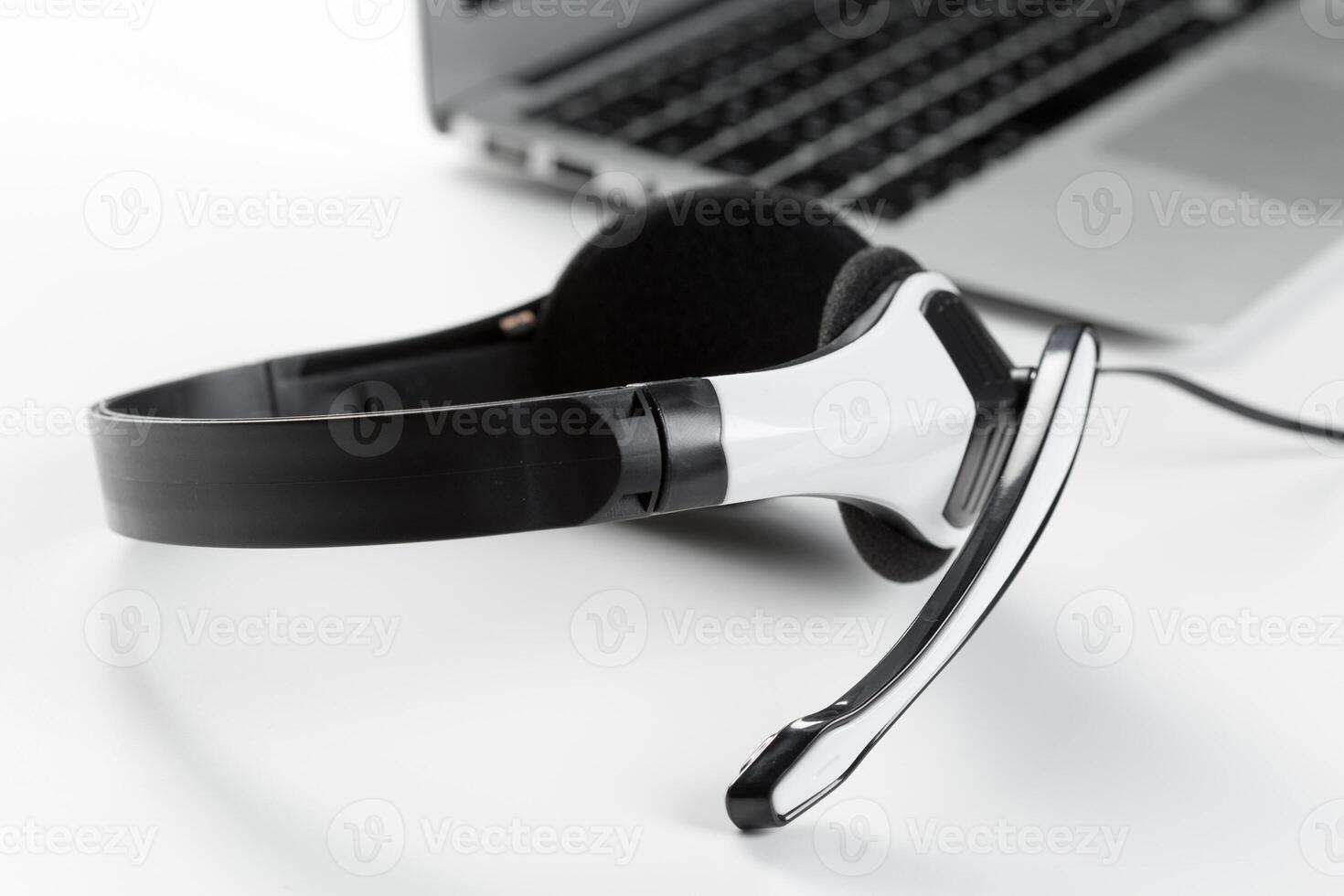 call center support concept. headset on keyboard computer laptop photo
