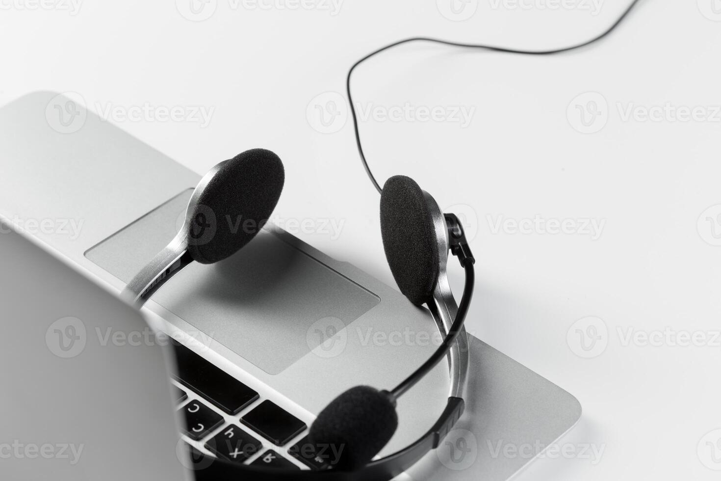 call center support concept. headset on keyboard computer laptop photo