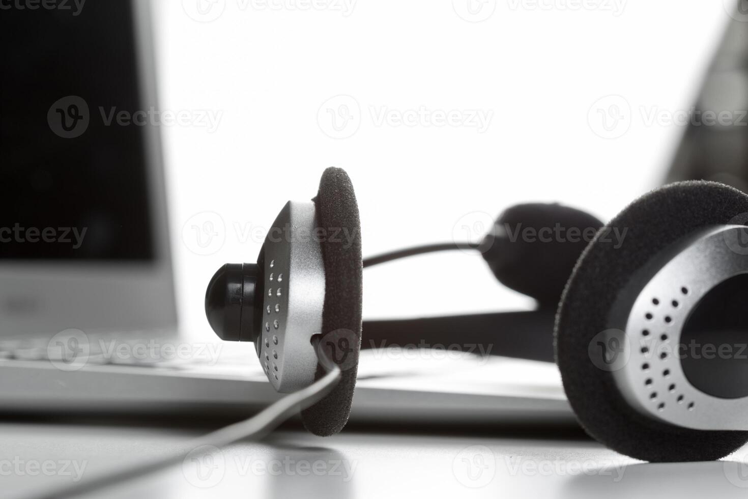 call center support concept. headset on keyboard computer laptop photo