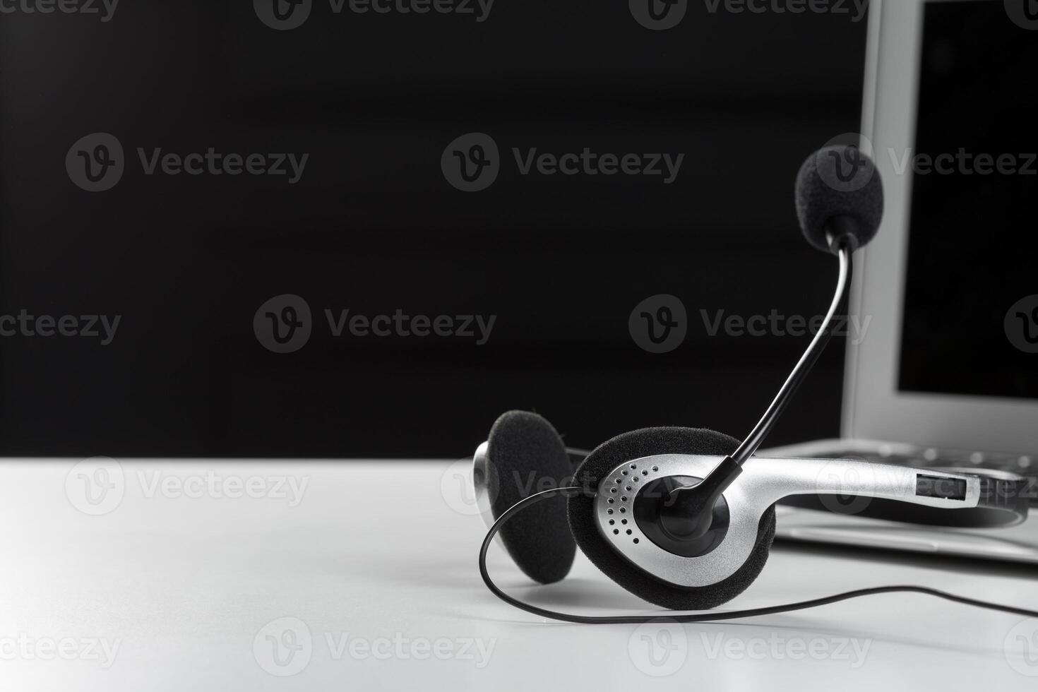 call center support concept. headset on keyboard computer laptop photo