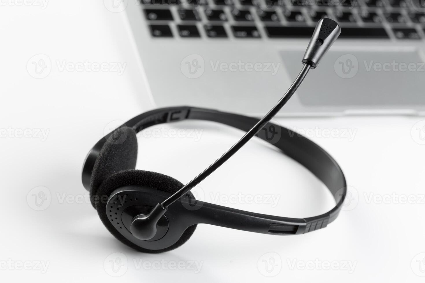 call center support concept. headset on keyboard computer laptop photo