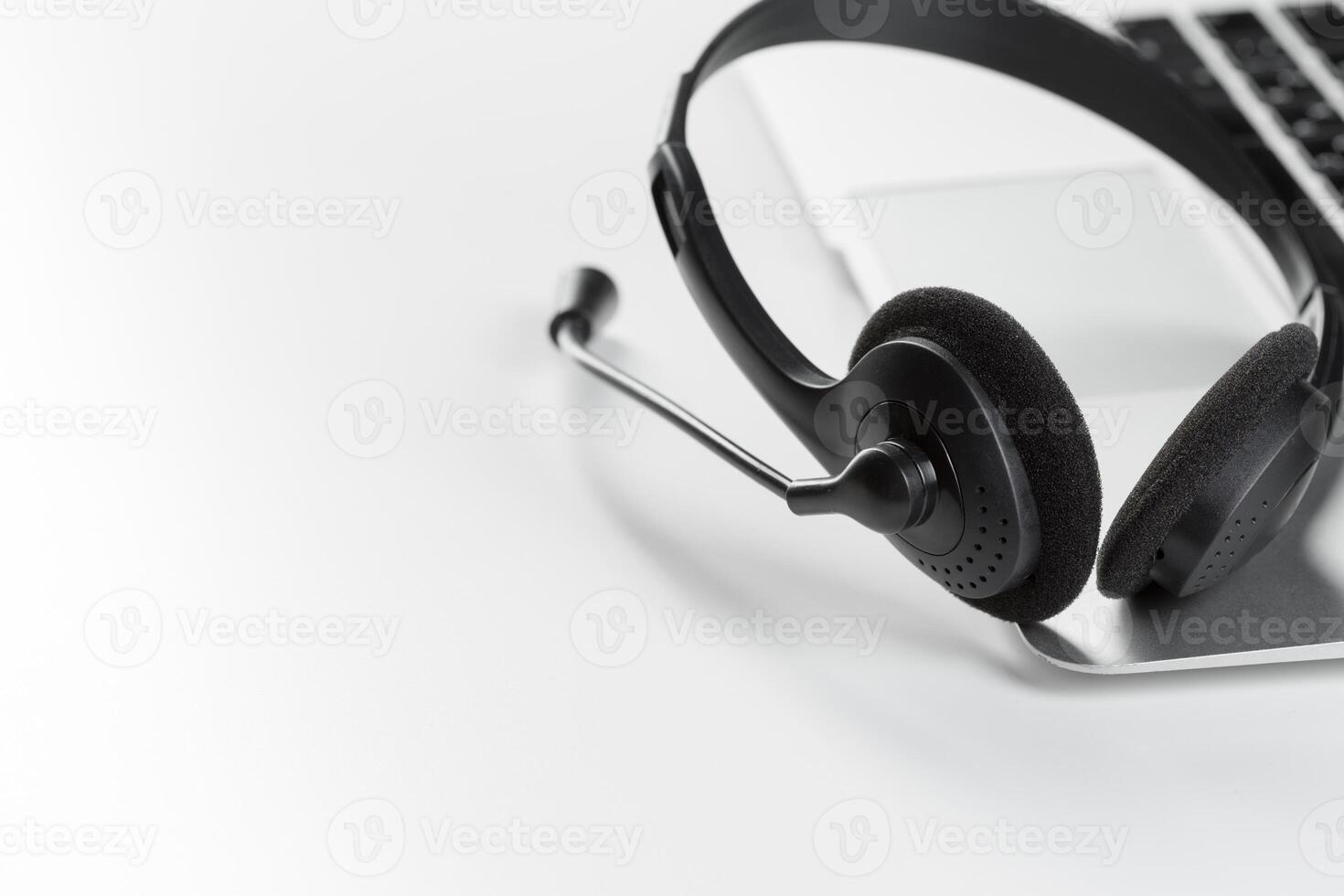 call center support concept. headset on keyboard computer laptop photo