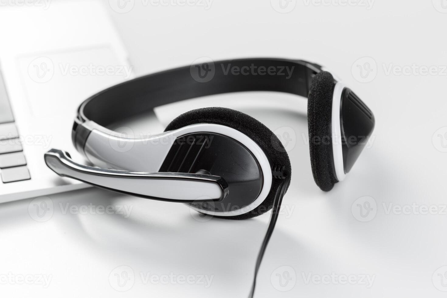 call center support concept. headset on keyboard computer laptop photo