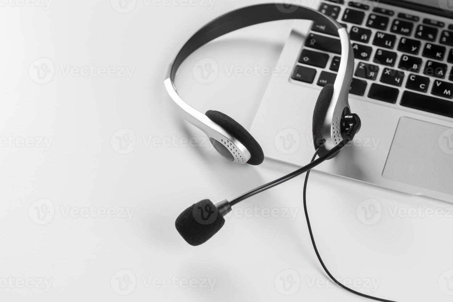 call center support concept. headset on keyboard computer laptop photo
