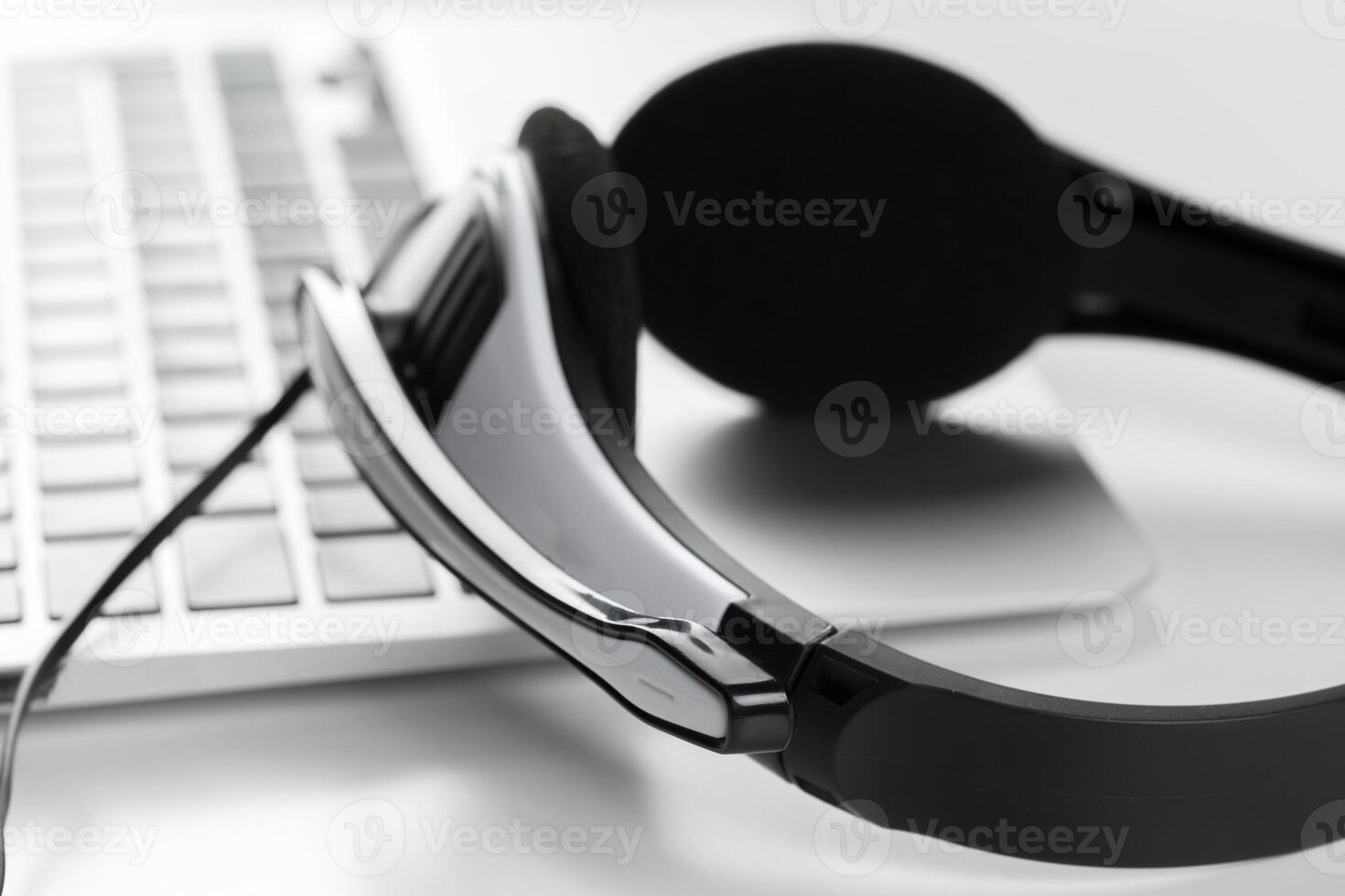 call center support concept. headset on keyboard computer laptop photo