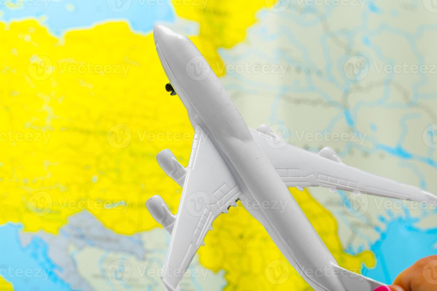 miniature of a passenger aircraft flying on a map photo