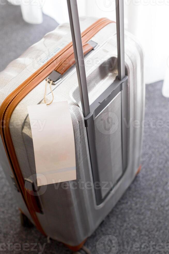 Close up of blank luggage tag label on a suitcase photo