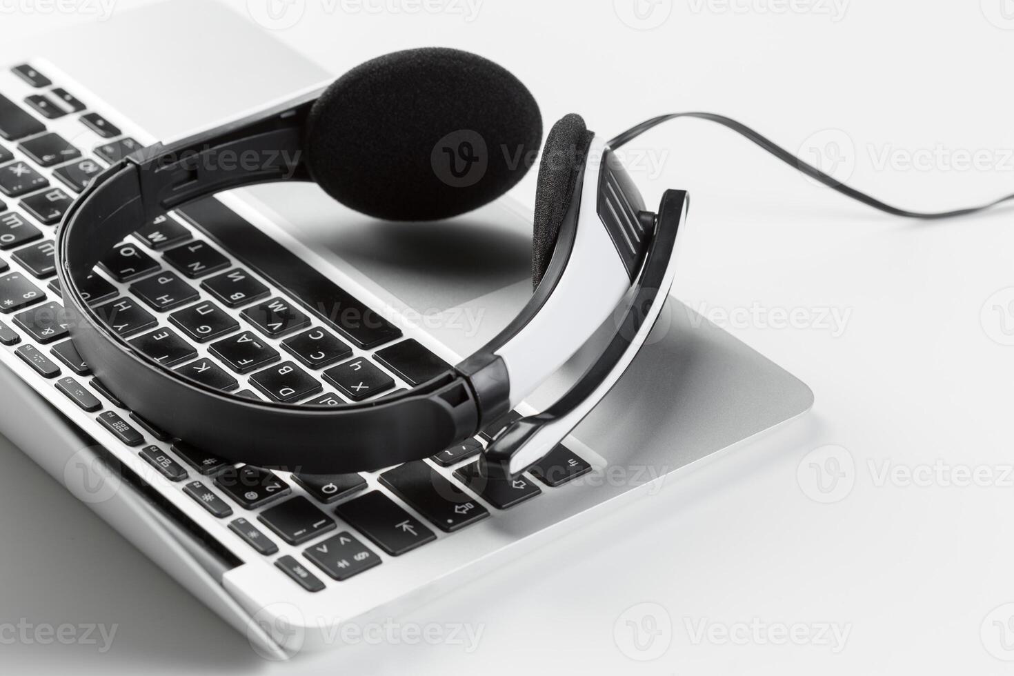 call center support concept. headset on keyboard computer laptop photo