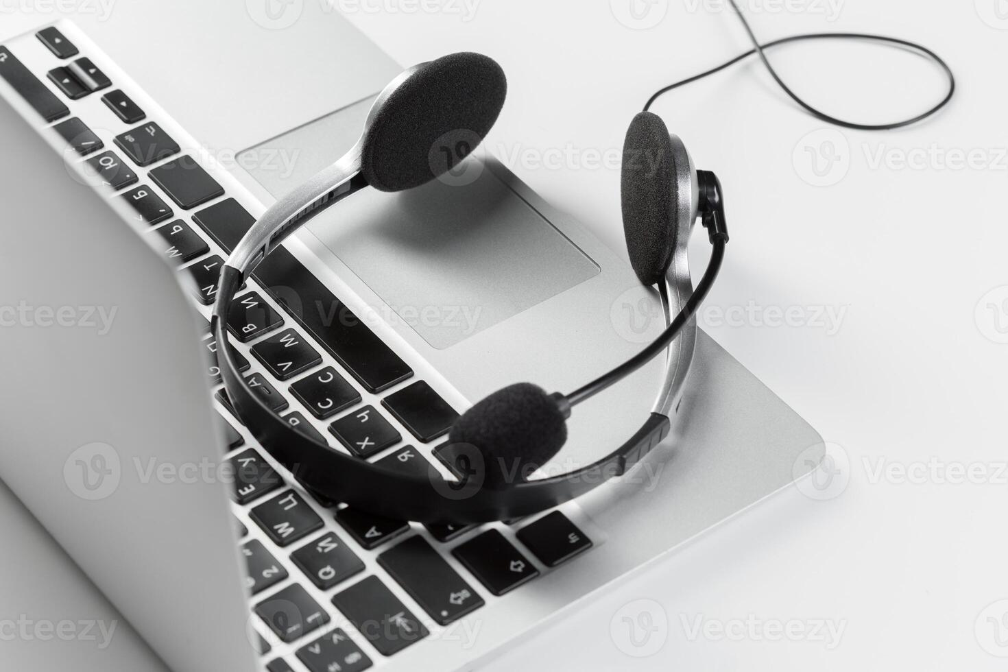 call center support concept. headset on keyboard computer laptop photo