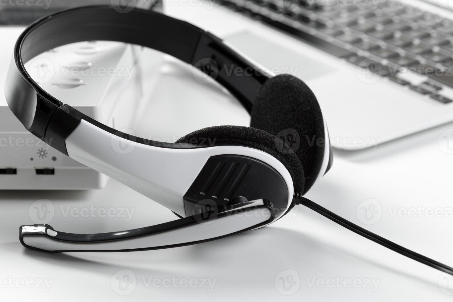 call center support concept. headset on keyboard computer laptop photo