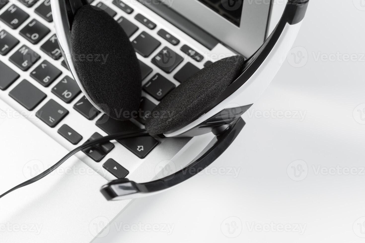 call center support concept. headset on keyboard computer laptop photo