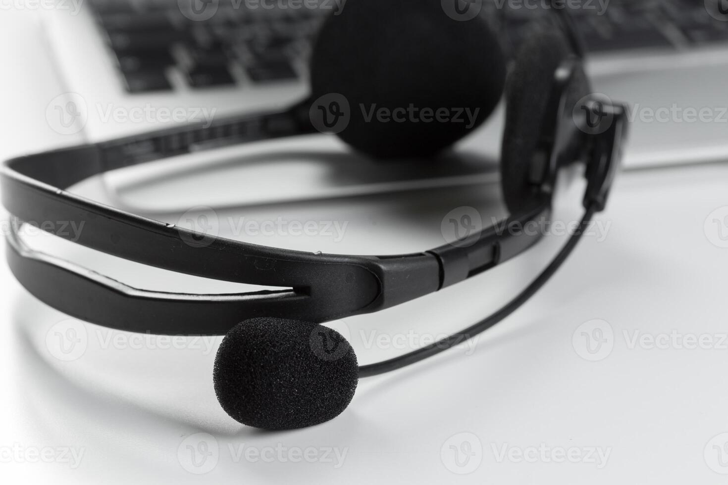 call center support concept. headset on keyboard computer laptop photo