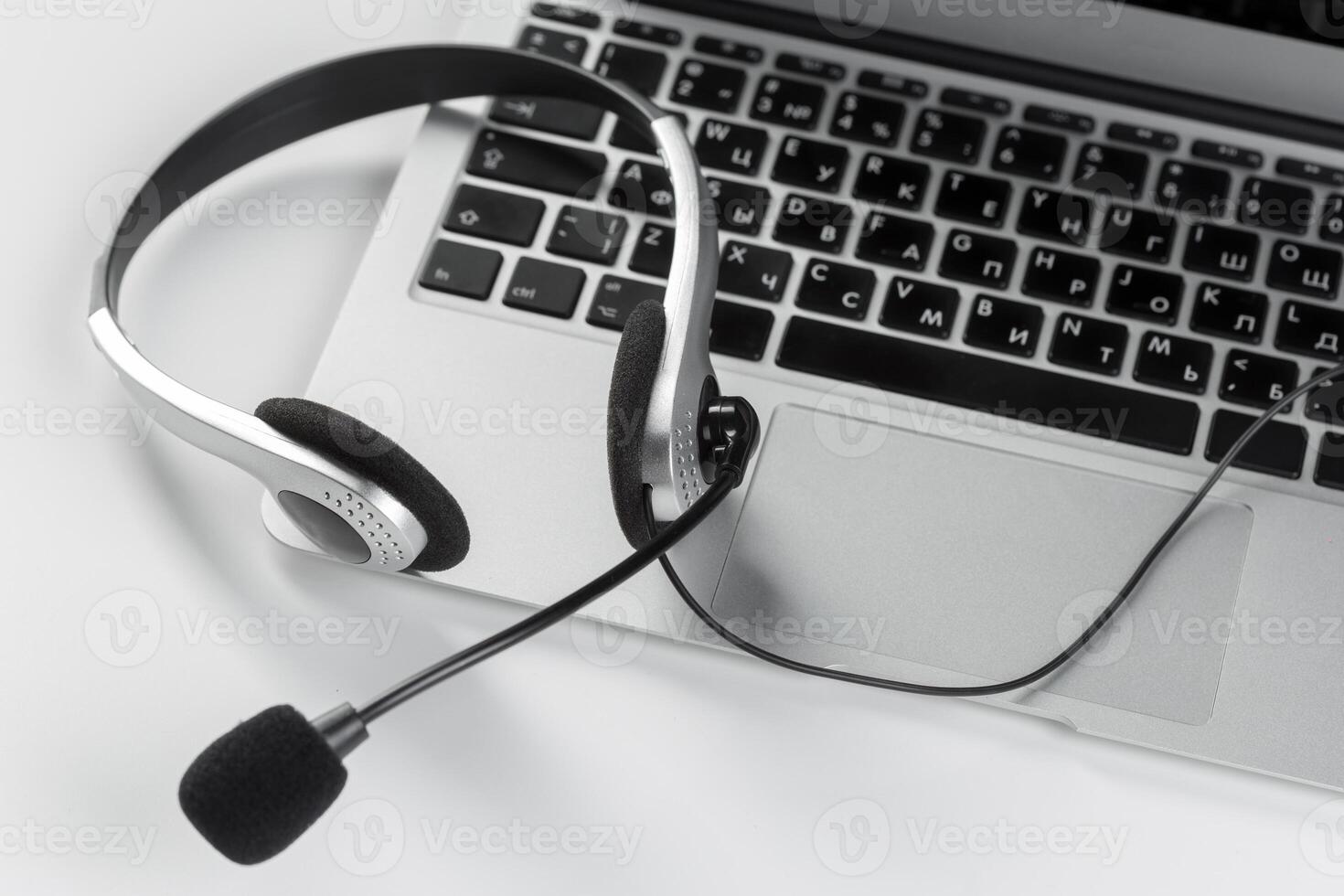 call center support concept. headset on keyboard computer laptop photo